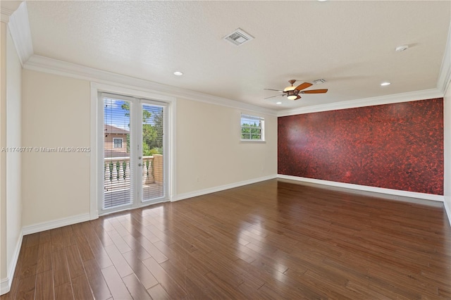 unfurnished room featuring dark wood-style floors, a textured ceiling, a wealth of natural light, and crown molding