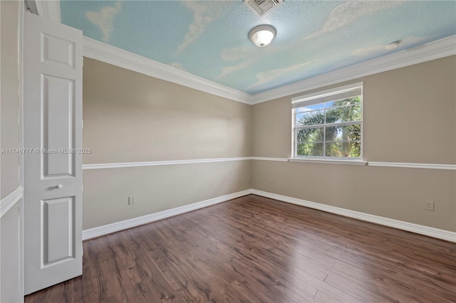 unfurnished room with crown molding, dark wood-style flooring, and baseboards