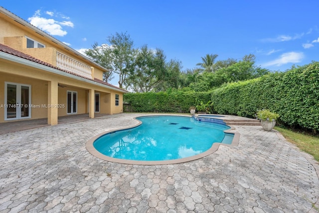 view of swimming pool with french doors, a patio area, and a fenced backyard