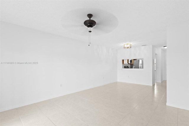 unfurnished room featuring light tile patterned floors and a ceiling fan