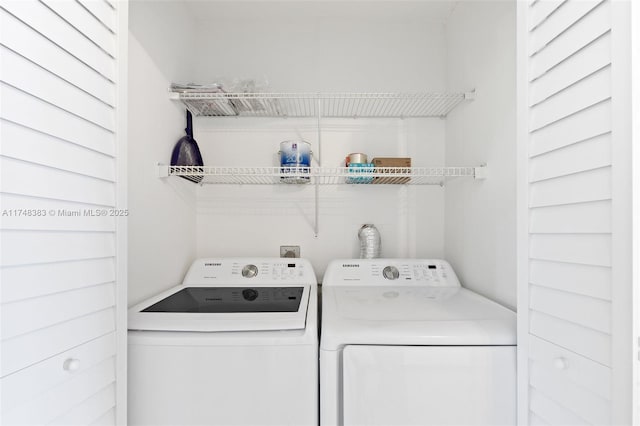 clothes washing area featuring laundry area and separate washer and dryer