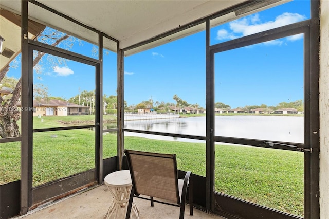 sunroom / solarium featuring a water view