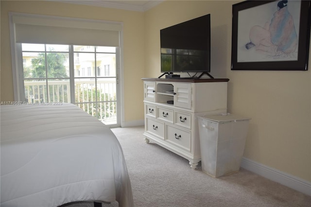 bedroom featuring access to exterior, light carpet, baseboards, and multiple windows