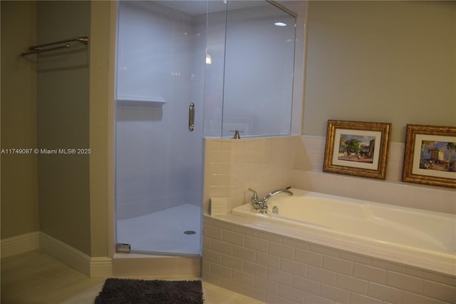 full bath featuring a stall shower and a bath