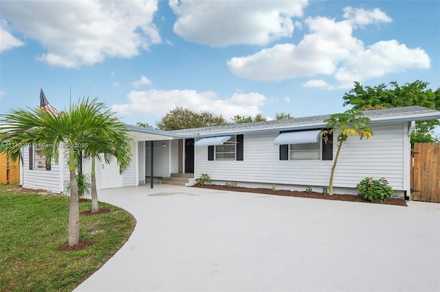 3883 Chickasha Rd, Lake Worth, FL 33462 - view of front of property featuring concrete driveway and an attached carport