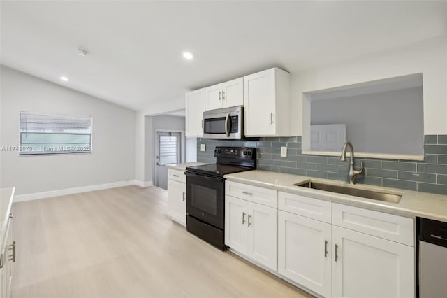 3883 Chickasha Rd, Lake Worth, FL 33462 - kitchen featuring black electric range oven, stainless steel microwave, dishwasher, tasteful backsplash, and vaulted ceiling