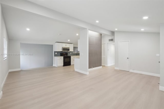 3883 Chickasha Rd, Lake Worth, FL 33462 - unfurnished living room featuring lofted ceiling, light wood finished floors, and recessed lighting