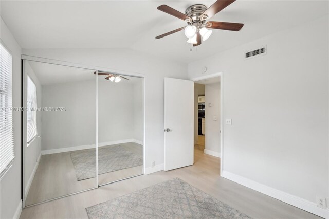 3883 Chickasha Rd, Lake Worth, FL 33462 - unfurnished bedroom featuring wood finished floors, lofted ceiling, a closet, and ceiling fan