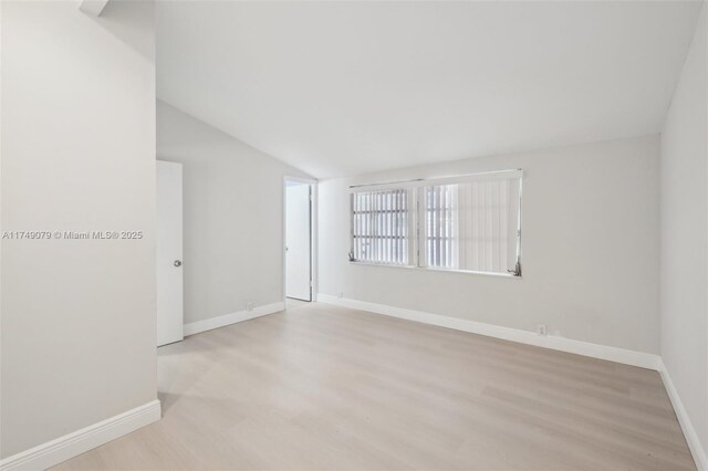 3883 Chickasha Rd, Lake Worth, FL 33462 - empty room featuring wood finished floors and lofted ceiling