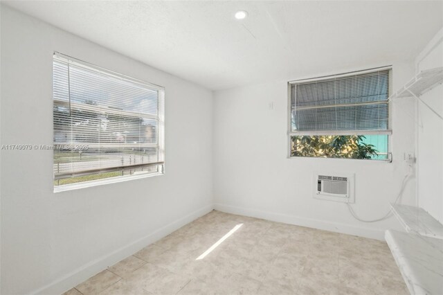 3883 Chickasha Rd, Lake Worth, FL 33462 - spare room featuring baseboards and a wall unit AC