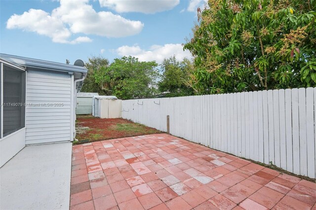 3883 Chickasha Rd, Lake Worth, FL 33462 - fenced backyard with a patio