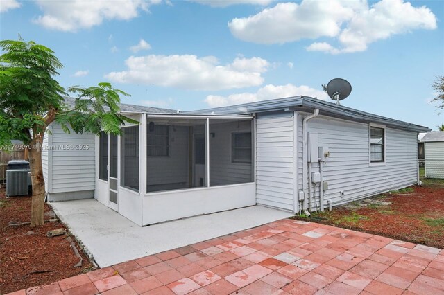 3883 Chickasha Rd, Lake Worth, FL 33462 - rear view of house featuring a sunroom and a patio area