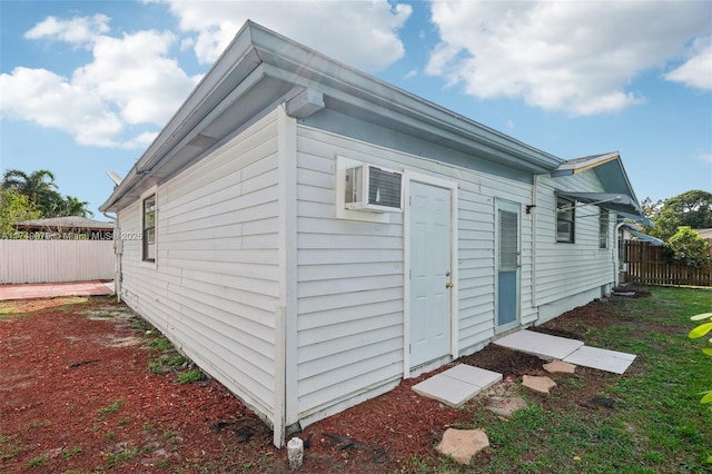 3883 Chickasha Rd, Lake Worth, FL 33462 - view of side of home featuring a wall unit AC