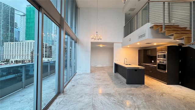 kitchen featuring a view of city, light countertops, visible vents, appliances with stainless steel finishes, and a sink