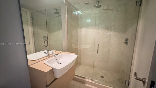 full bath featuring tile patterned flooring, a shower stall, and a sink