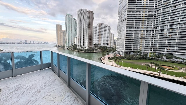 balcony with a water view and a city view