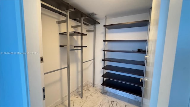 spacious closet with marble finish floor and visible vents