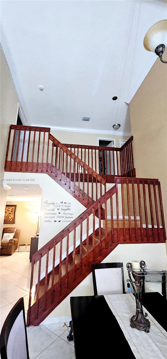 stairway with tile patterned flooring