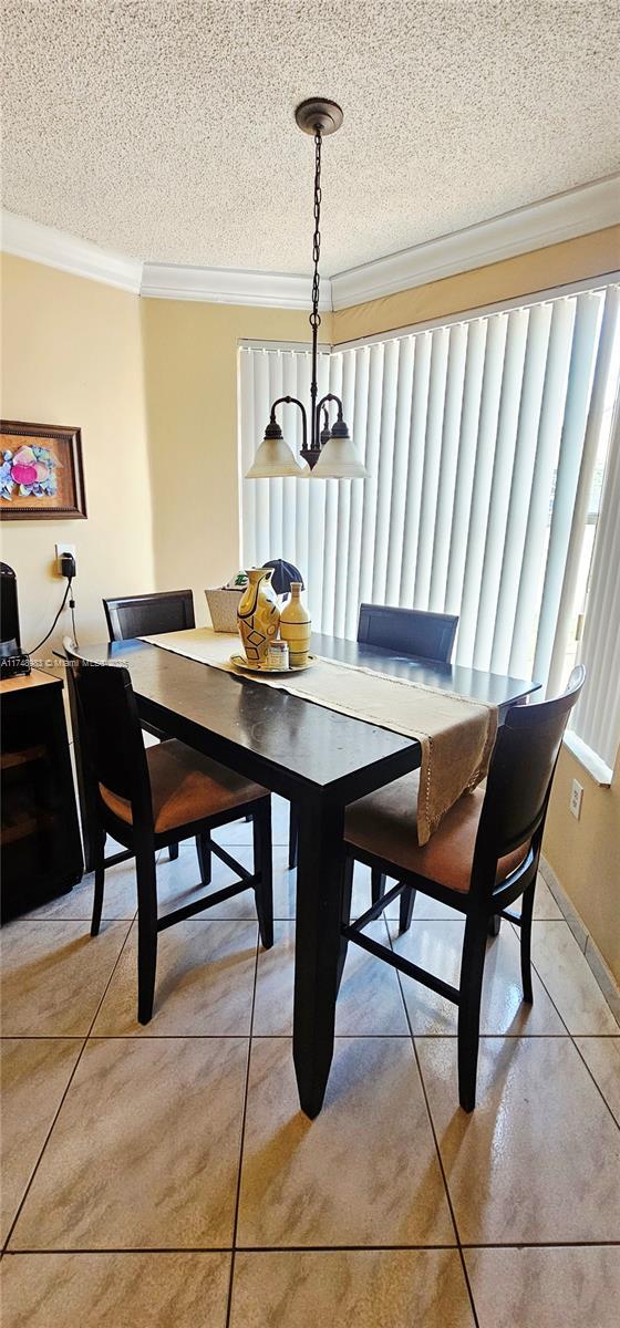 18860 NW 12th St, Pembroke Pines, FL 33029 - dining area with crown molding, a textured ceiling, and light tile patterned floors