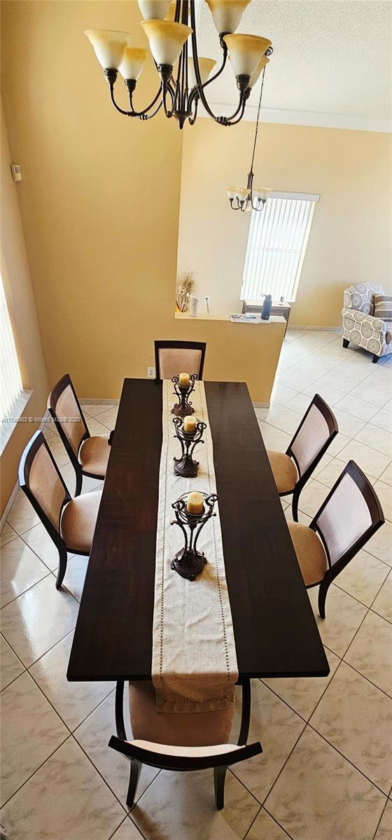 18860 NW 12th St, Pembroke Pines, FL 33029 - dining area with a chandelier, crown molding, and a textured ceiling