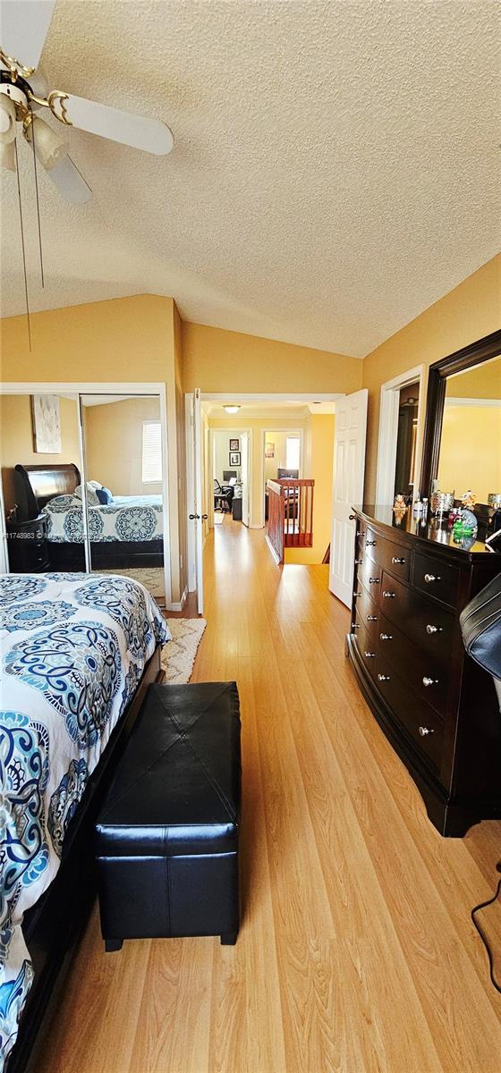 18860 NW 12th St, Pembroke Pines, FL 33029 - bedroom with a textured ceiling, light wood finished floors, ceiling fan, and a closet