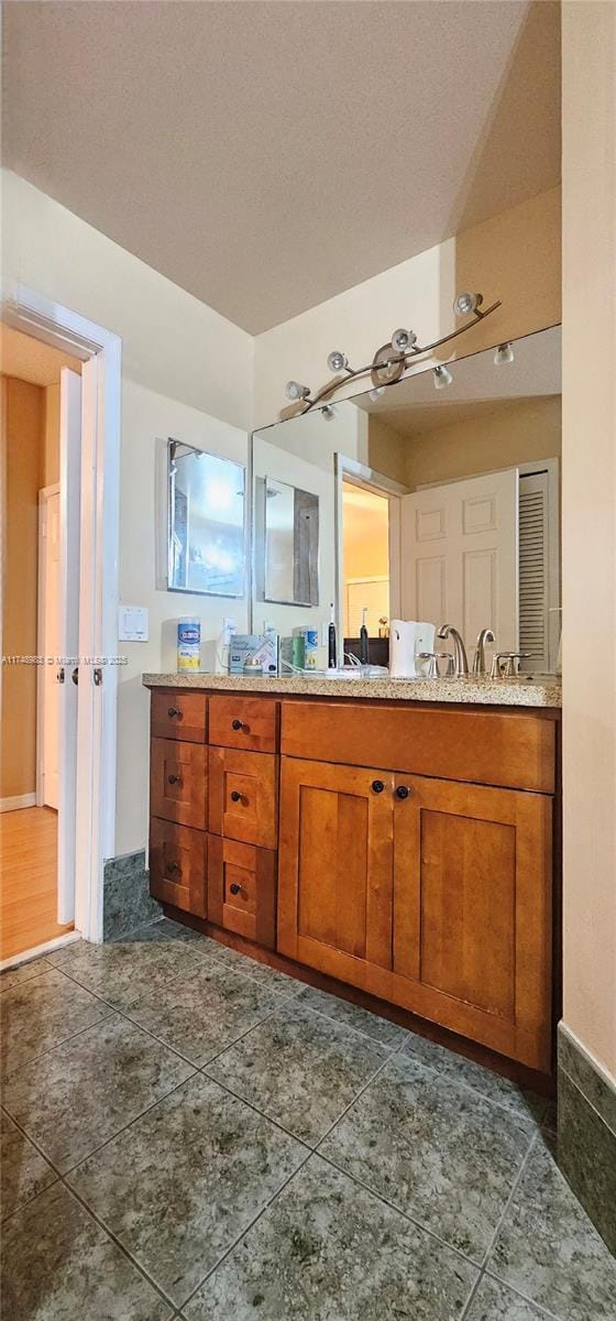 full bathroom featuring tile patterned floors and double vanity