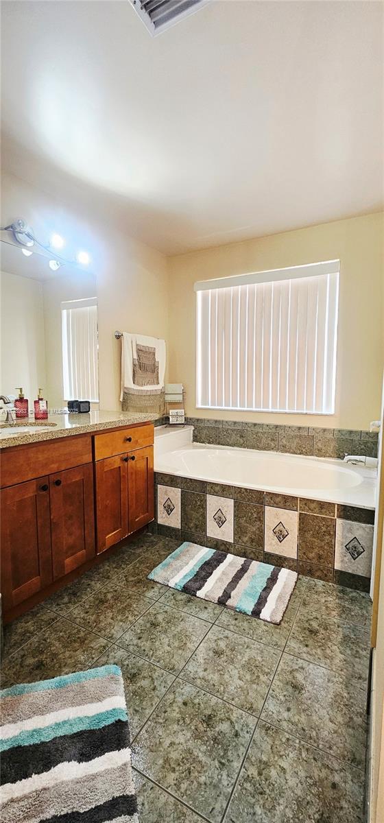 18860 NW 12th St, Pembroke Pines, FL 33029 - bathroom with a garden tub, vanity, and tile patterned floors