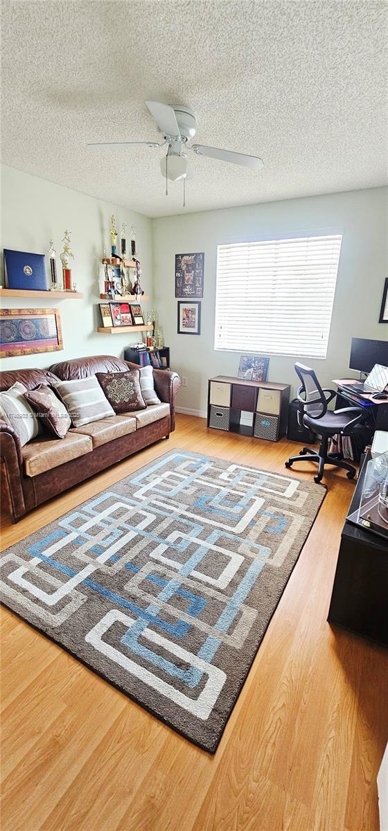 18860 NW 12th St, Pembroke Pines, FL 33029 - living area with wood finished floors, ceiling fan, and a textured ceiling