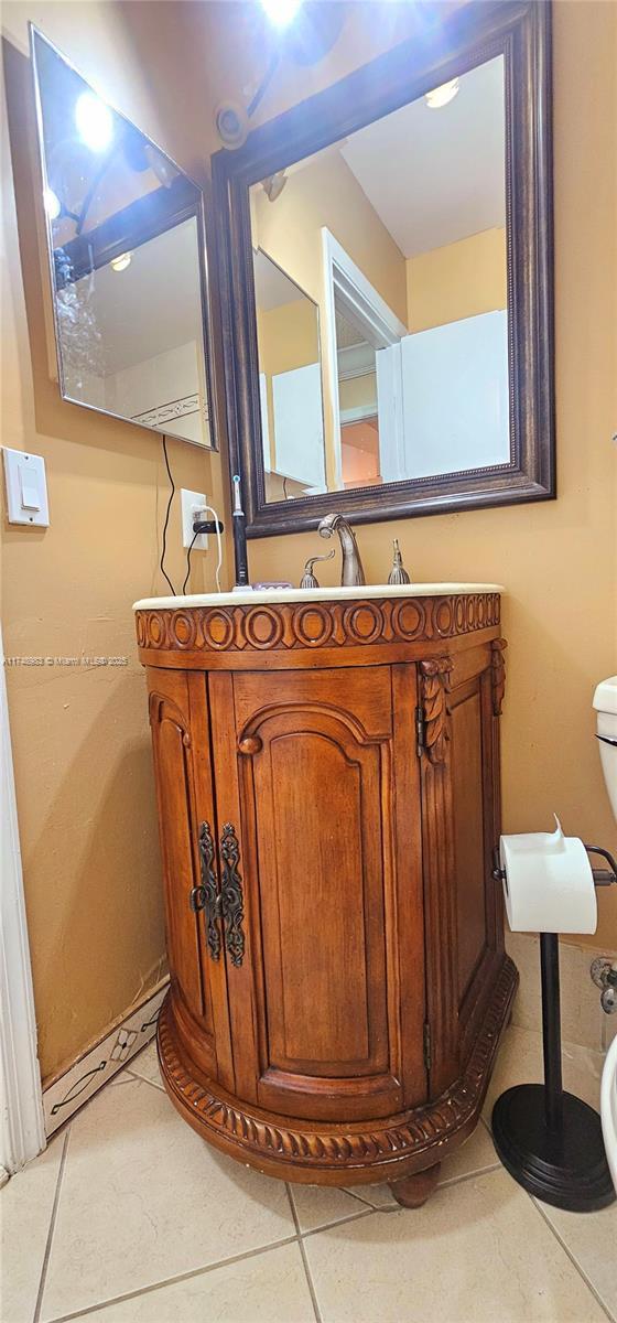 bathroom featuring vanity, toilet, and tile patterned floors