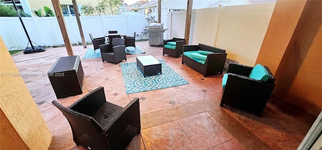 view of patio / terrace featuring a fenced backyard, a grill, outdoor lounge area, and outdoor dining space