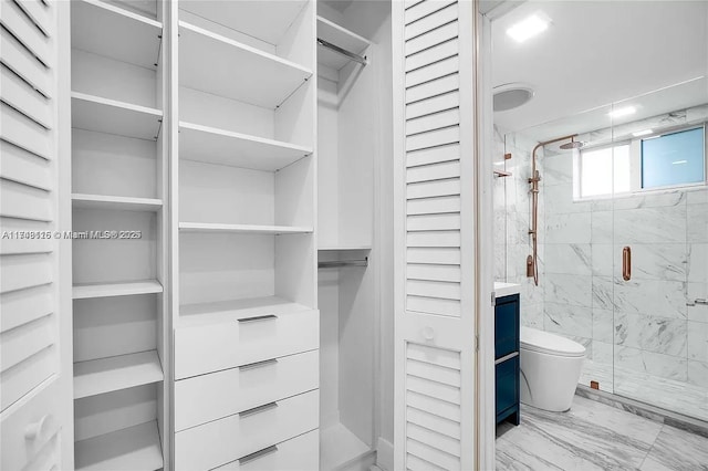 spacious closet featuring marble finish floor