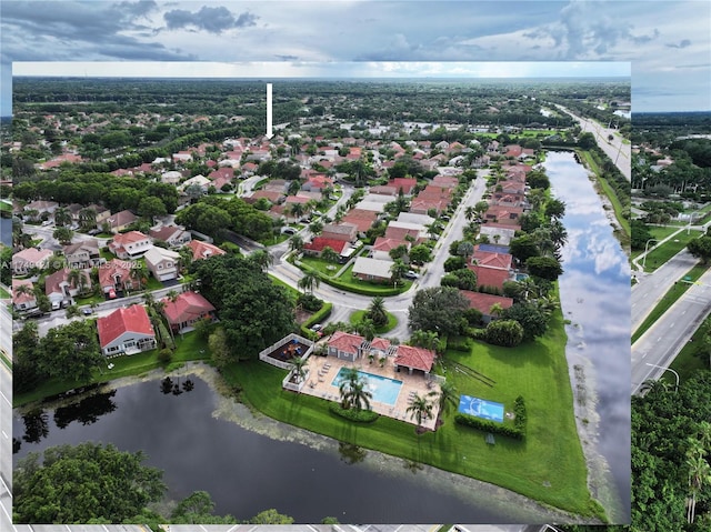 drone / aerial view with a residential view and a water view