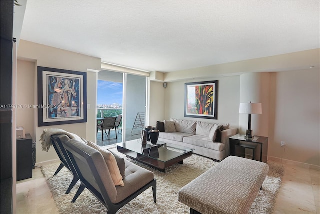 living room with a textured ceiling and baseboards