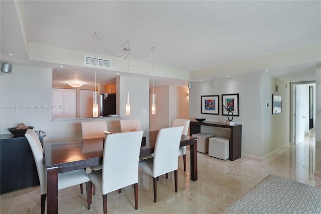 dining room with recessed lighting, visible vents, a textured ceiling, and baseboards