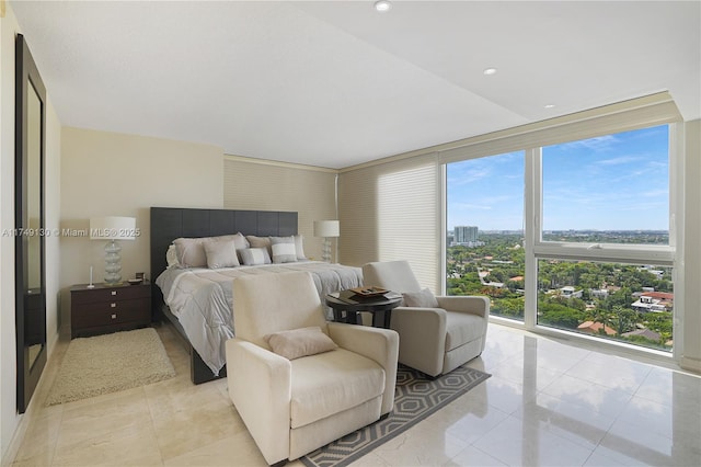 bedroom featuring expansive windows, light tile patterned floors, a view of city, and recessed lighting