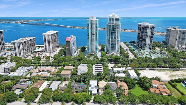 birds eye view of property with a view of city and a water view