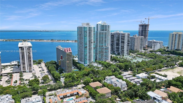 birds eye view of property with a water view and a city view