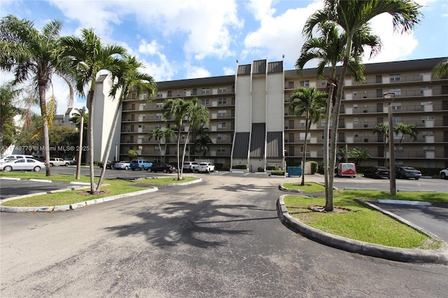 view of building exterior featuring uncovered parking