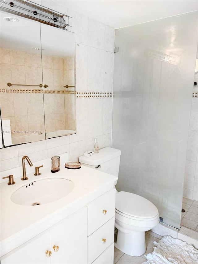 full bath with toilet, vanity, tile walls, tasteful backsplash, and walk in shower