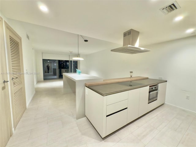 1000 Brickell Plz Unit 4314, Miami, FL 33131 - kitchen featuring island exhaust hood, oven, electric stovetop, white cabinets, and dark countertops