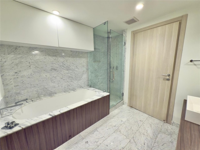 1000 Brickell Plz Unit 4314, Miami, FL 33131 - bathroom with a stall shower, a bath, and marble look tile flooring