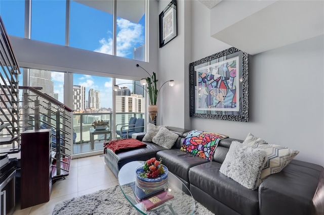 living area featuring a city view, a high ceiling, and light tile patterned floors