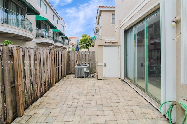 view of patio / terrace featuring cooling unit and fence