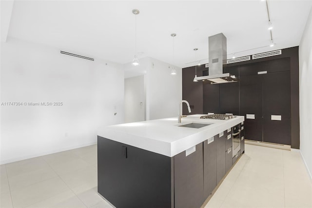 kitchen featuring island range hood, a sink, modern cabinets, a center island with sink, and pendant lighting