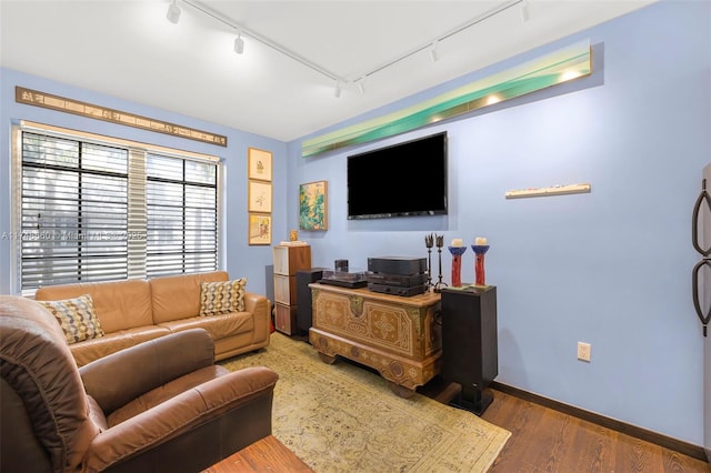 living room with rail lighting, baseboards, and wood finished floors