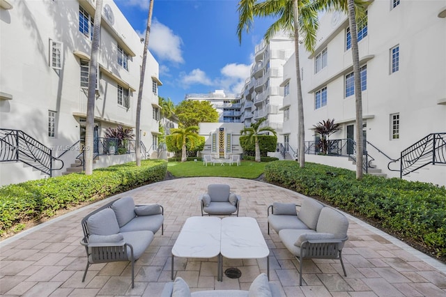 surrounding community featuring a patio and an outdoor living space