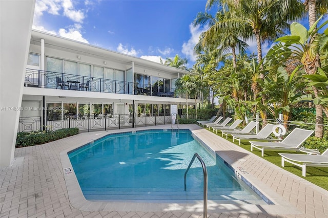 pool featuring fence and a patio