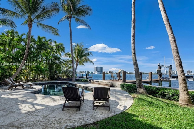 view of pool featuring a water view and a dock