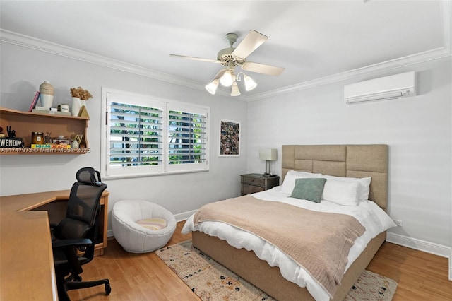 bedroom with ornamental molding, a wall unit AC, baseboards, and wood finished floors