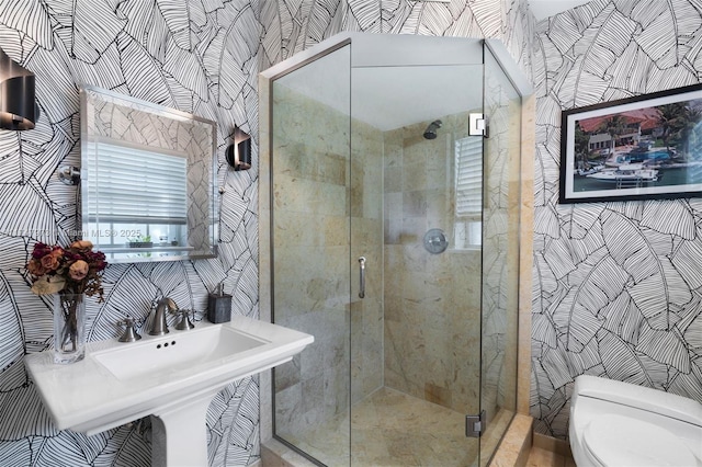 full bath with a shower stall, toilet, and wallpapered walls